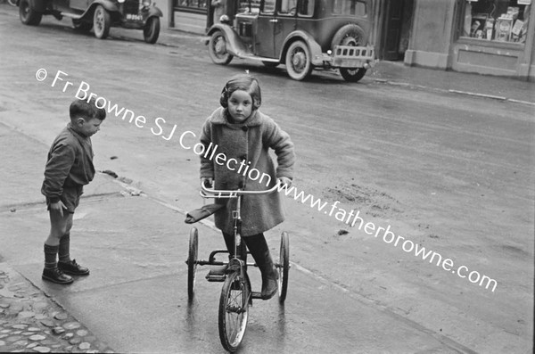 BOY ON TRICYCLE